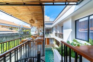a view from the balcony of a hotel with a swimming pool at Sekala CoLiving Canggu - Minutes away to Finns and Atlas Beach Clubs in Canggu