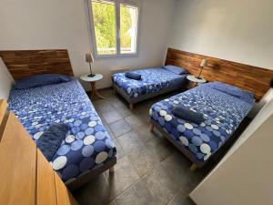 a room with two beds and two tables at Le Pavot in La Tranche-sur-Mer +54 photos