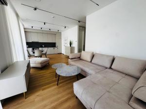 a living room with a couch and a table at Apartment in the city center near park and river 5 in Marijampolė +1 photo