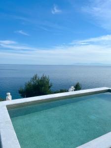 a swimming pool with a view of the ocean at Koumaros Villas in Agia Paraskevi +142 photos