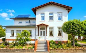 a white house with solar panels on it at Villa Meeresglück in Sassnitz