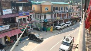 an aerial view of a city with cars parked on a street at Punchkedar in Phata
