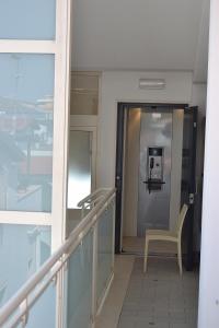 an elevator in a building with a chair in a hallway at Appartamenti In Residence Zoe in Roseto degli Abruzzi