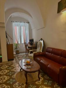 a living room with a couch and a table at Old Town in Castellana Grotte +6 photos