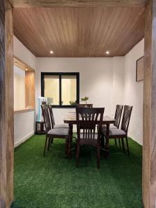 a dining room with a wooden table and chairs at Cozy Loft 201 2 BHK in Jaipur +27 photos