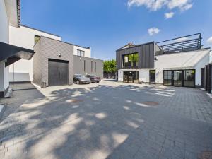 a parking lot with two buildings and a car at Romantic Studio Marki LoveAparts in Marki