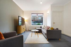 a living room with a couch and a table at Your Second Home - Work Stay - Free Parking in Bishop Auckland