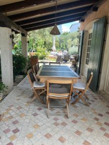 a ping pong table and chairs on a patio at The GOOD PLACE in Murter