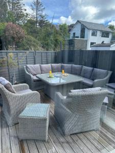 a patio with a table and chairs on a deck at Waters Reach in Abersoch