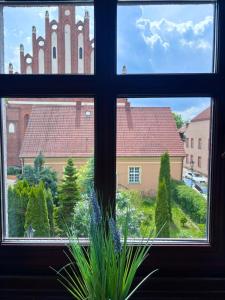 a window with a view of a church at OLD TOWN Olsztyn in Olsztyn