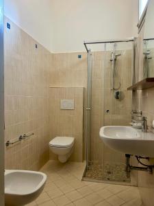 a bathroom with a toilet and a sink and a shower at Hotel Canasta in Misano Adriatico