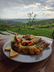 a white plate of food on a table at Panorama Cehu Silvaniei in Cehu Silvaniei