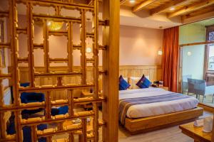 a bedroom with a bed with a wooden frame at Hotel Rewa Ladakh in Leh +90 photos