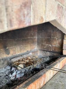 a cage filled with bees in a brick fireplace at Istisu Valley Spa in İsmayıllı
