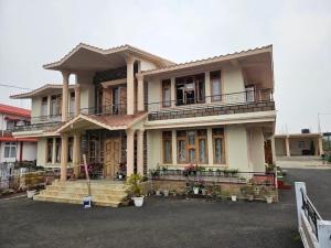 a large house with a balcony on top of it at Salena Homestay in Cherrapunji +17 photos