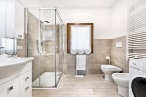 a bathroom with a shower and a toilet and a sink at Eden Beach House - Host Solution in Cavallino-Treporti