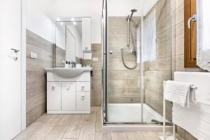 a bathroom with a shower and a sink at Eden Beach House - Host Solution in Cavallino-Treporti +31 photos