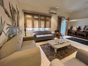 a living room with a couch and a table at Cozy Loft 201 2 BHK in Jaipur