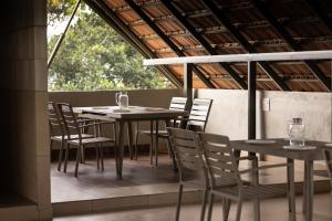 a group of tables and chairs on a patio at Kayn by spynora in Vythiri