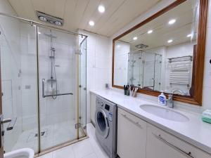 a bathroom with a sink and a washing machine at Anju Apartment in Beijing +123 photos