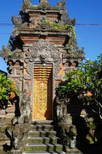 an entrance to a building with a gold door at Tegeg's Homestay in Keramas +66 photos