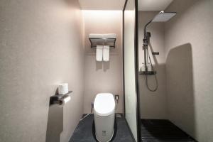 a small bathroom with a toilet and a shower at 上海安鉌蓓斯特酒店国家会展中心虹桥机场店 in Hongqiao Intl +12 photos
