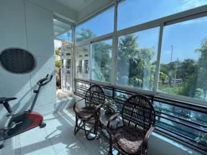 a balcony with three chairs and a treadmill at Cozy Loft 201 2 BHK in Jaipur