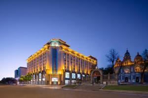a large building with lights on it at night at Sunworld Dynasty Hotel Beijing Wangfujing in Beijing