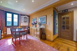 a dining room with a table and chairs in it at Casa Familiar Etxabe-Enea in Lasarte +28 photos