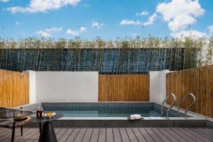 a patio with a pool and a wooden fence at 自由鸟觅野山舍-阳朔十里画廊遇龙河店 in Yangshuo