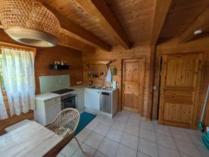 a kitchen in a log cabin with a table and chairs at FeWo Aus'm Garten im Holzblockhaus nähe Aachen in Eschweiler