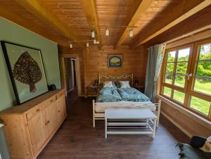 a bedroom with a bed in a wooden cabin at FeWo Aus'm Garten im Holzblockhaus nähe Aachen in Eschweiler