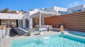 a villa with a swimming pool and a house at Villa Ida - Indoor Heated Pool, Sauna, Games Room and Gym in Mellieħa