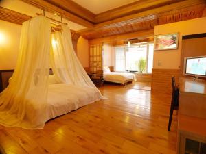 a bedroom with a bed with a mosquito net at Sun Moon Bed& Breakfast 日月民宿 in Wulai +37 photos