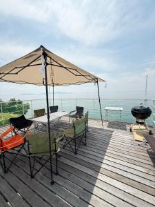 a patio with a table and chairs and an umbrella at fully in Otsu