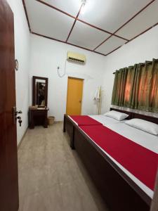 a bedroom with a large bed in a room at Luckwin Guest in Anuradhapura +5 photos