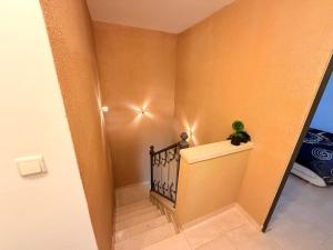 a hallway with a staircase with a plant on it at Olympus B&B in Mitzpe Ramon +5 photos