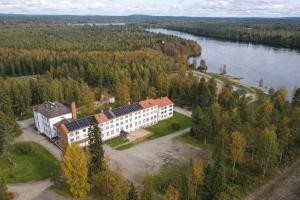 an aerial view of a building next to a body of water at Hotel Metsähirvas in Rovaniemi