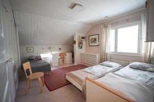 a small room with two beds and a table at Villa Golden Haven in Rovaniemi