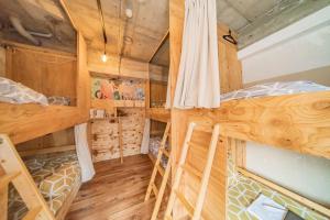 two bunk beds in a room with wooden walls at ArtBar & GuestHouse ennova in Atami +26 photos