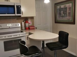 a kitchen with a table and a stove and chairs at Love Capilano in North Vancouver
