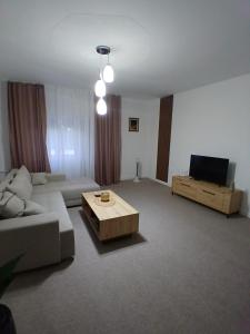 a living room with a couch and a coffee table at OAZA Miokus in Miokus