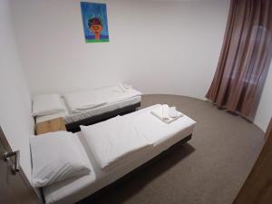 a room with three beds and a painting on the wall at OAZA Miokus in Miokus +45 photos