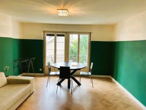 a living room with a table and a couch at 3 Room Old Town Flat - Munster in Zurich