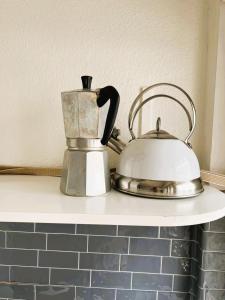 a tea kettle sitting on top of a counter at 3 Room Old Town Flat - Munster in Zurich