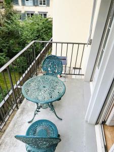 a patio with two chairs and a table on a balcony at 3 Room Old Town Flat - Munster in Zurich