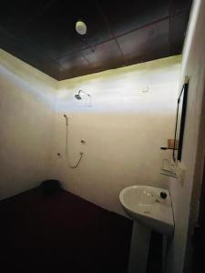 a bathroom with a sink and a light on the wall at Moon Light Villa in Panama