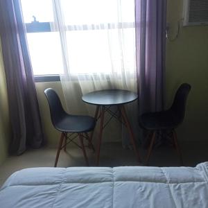 two chairs and a table in front of a window at Horizon101 in Cebu City