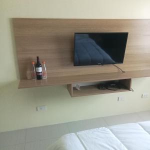 a flat screen tv on a wall in a bedroom at Horizon101 in Cebu City