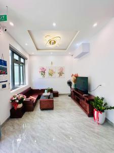 a living room with a couch and a television at weolhouse in Hue